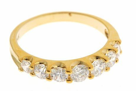 Electra graduated round lab grown diamond alternative cubic zirconia prong set anniversary band in 14k yellow gold.