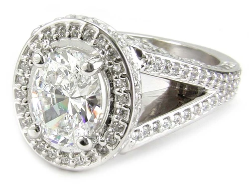 TomKat 2.5 carat oval laboratory grown diamond simulant cubic zirconia pave halo split shank solitaire engagement ring in 14k white gold.