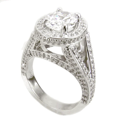 TomKat 2.5 carat oval laboratory grown diamond alternative cubic zirconia pave halo split shank solitaire engagement ring in platinum.