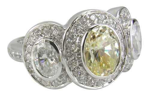 Cavalier 1 carat oval center lab created cubic zirconia three stone pave set halo engagement ring in 14k white gold.