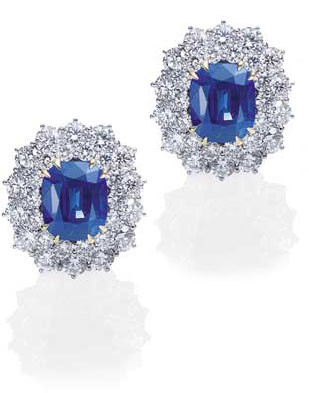 Oval 4 carat man made sapphire blue gemstone lab grown diamond simulant cubic zirconia cluster halo earrings in 14k white gold.