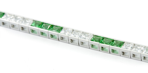 Channel Set Princess Cut Tennis Bracelet with alternating man made emerald green gemstones and lab grown diamond simulant cubic zirconia in 14k white gold.