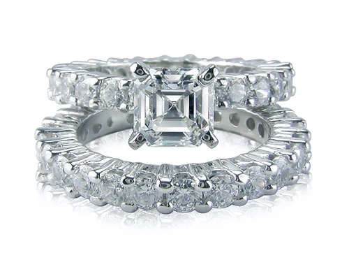 1.5 Carat Emerald Radiant Cut Cubic Zirconia Eternity Solitaire with Matching Round Eternity Band with lab grown diamond simulant cubic zirconia.
