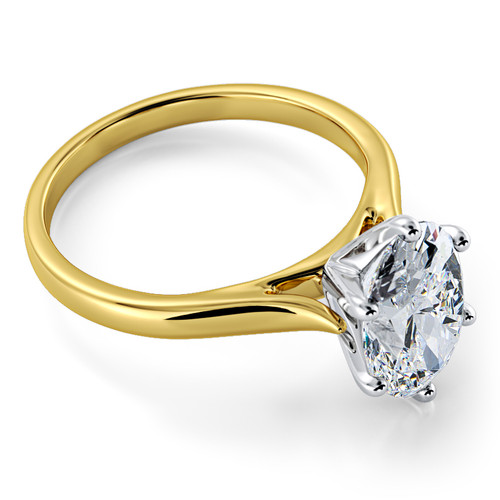 Oval 1.5 carat laboratory grown diamond look cubic zirconia cathedral solitaire engagement ring in 14k yellow gold with white gold prongs.