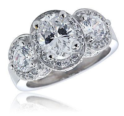 Vanessa 1.5 carat oval lab created cubic zirconia pave halo three stone ring in platinum.
