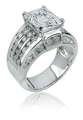Ellise 4 carat emerald step cut lab grown diamond alternative cubic zirconia channel solitaire engagement ring in 14k white gold.