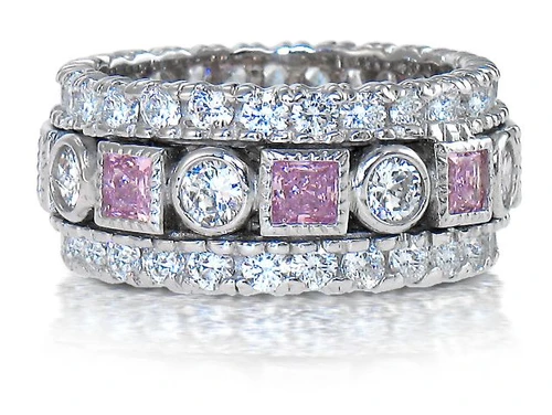 Fantasy alternating round and pink princess cut lab grown diamond simulant cubic zirconia eternity band in 14k white gold.