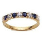 Prong set round lab grown diamond look cubic zirconia and man made sapphire anniversary band in 14k yellow gold.