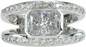 Karand 1.5 carat bezel set emerald radiant cut lab grown diamond simulant cubic zirconia split shank engagement ring in platinum.