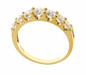 Electra graduated round lab created cubic zirconia prong set anniversary band in 14k yellow gold.