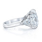 Montague elongated cushion with pear sides three stone ring featuring laboratory grown diamond simulant cubic zirconia three stone engagement ring in platinum.