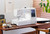 Picture of a Janome MC1000 sitting on a brown sewing table in a sewing studio