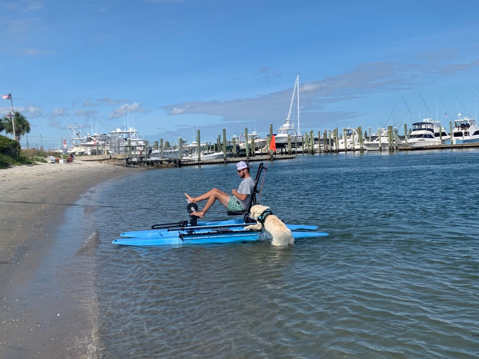 Man and dog with a portable kayak