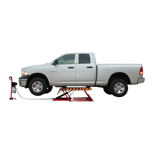 white dodge ram truck on a low rise car lift