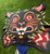 An angle view showcasing the detail of Grimalkin handmade hand painted holiday themed halloween woodcut cat