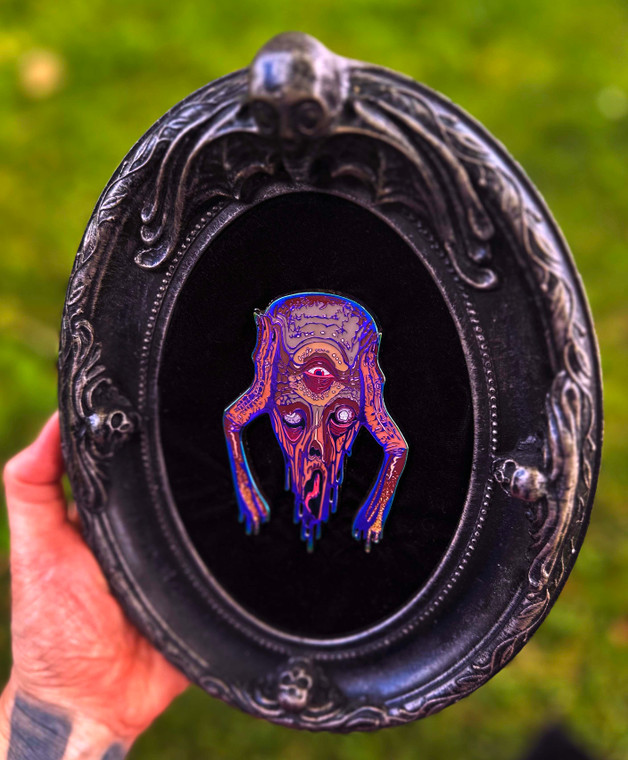 A custom framed chet zar enamel pin. The melt enamel pin and custom frame are both long discontinued designs making for a rare combo!
