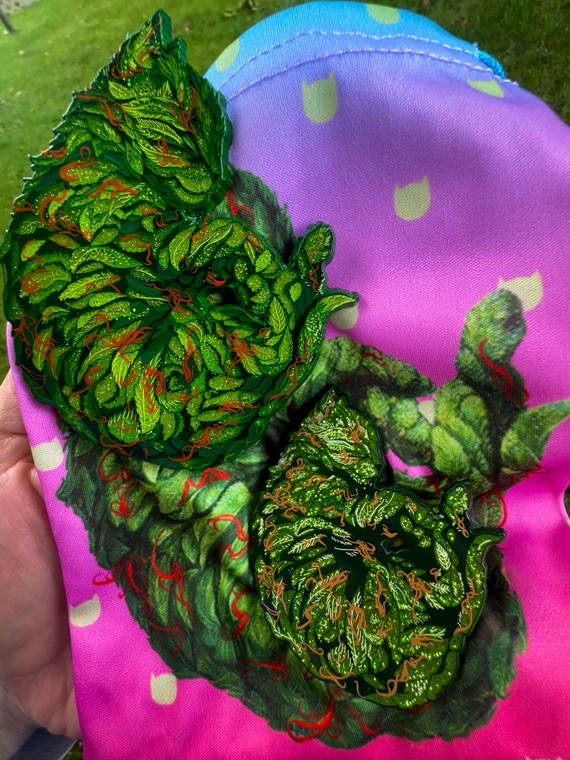 OG meowie wowie with unauthorized bootleg. A rare showcase of the classic enamel pin next to the imitation copy.