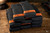 Black AR magazines banded with orange SPARTA 300 Blackout markers, stacked on a wood bench