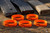 Five orange SPARTA 300 Blackout bands laid out beside three AR magazines ready to be marked