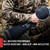 Hunter in grips a shotgun forend wrapped in black non-slip gun grip tape, with a zoomed inset showing rain beading on the water-resistant matte polycotton weave.