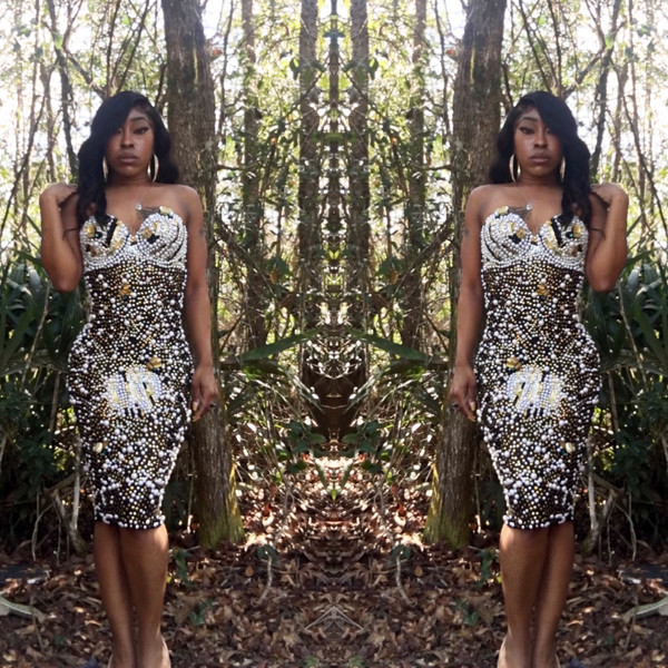 Bold and daring dress adorned with swarovskis, pearls, applique's, and  sequin on the front and back with built in bra.