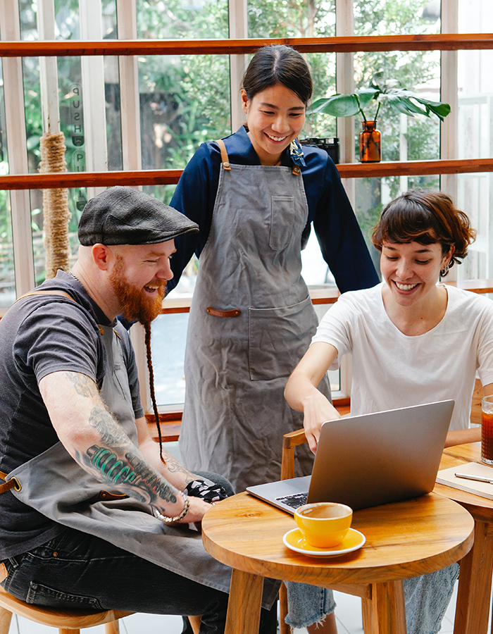 Three Friends Looking at a Laptop