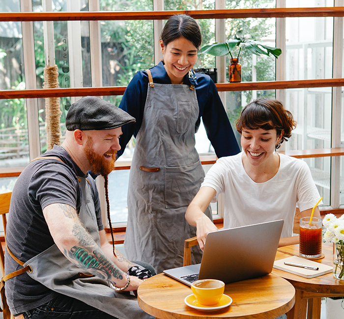 Three Friends Looking at a Laptop