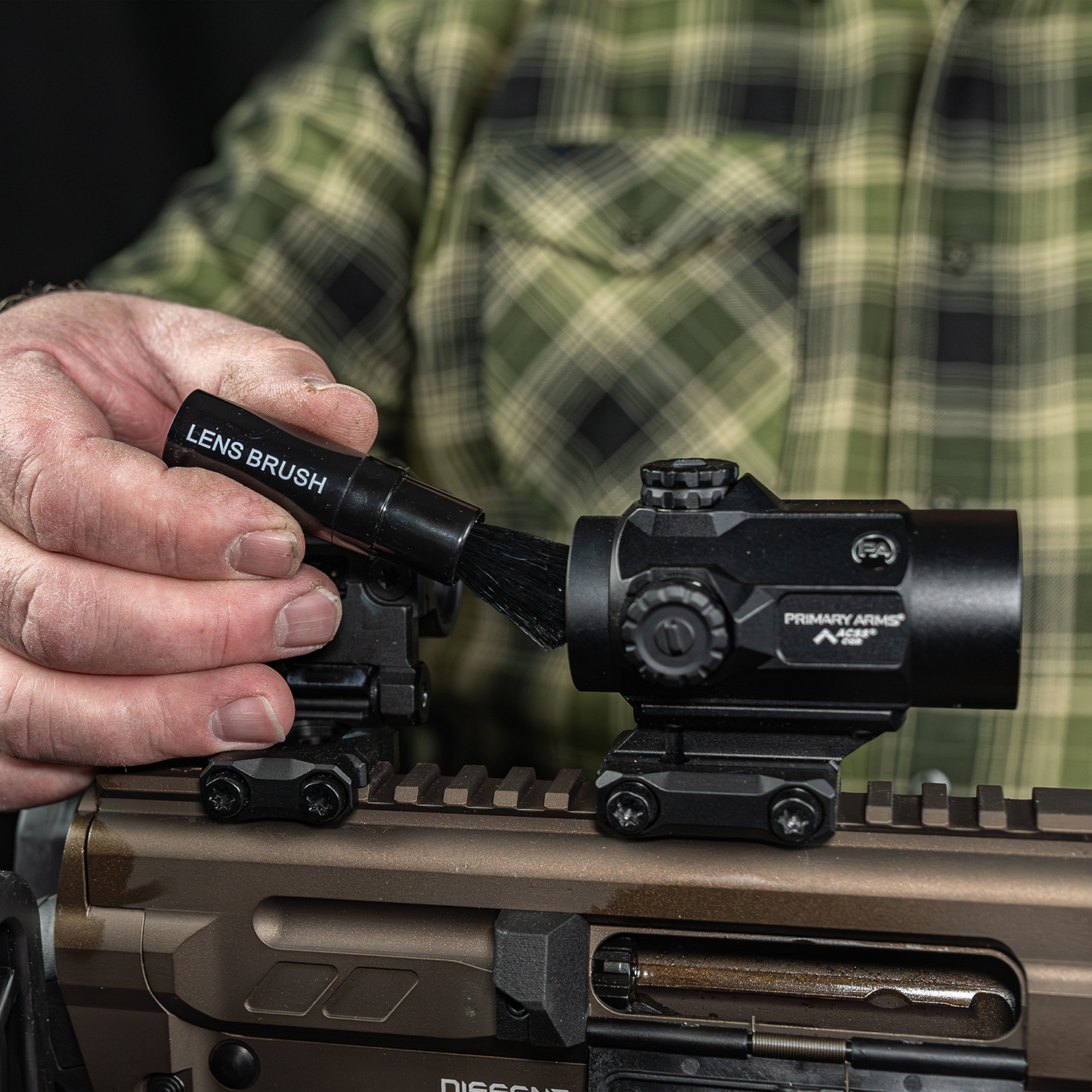 Lifestyle Product image of Otis Technology Lens Cleaning kit lens brush in use on red dot sight