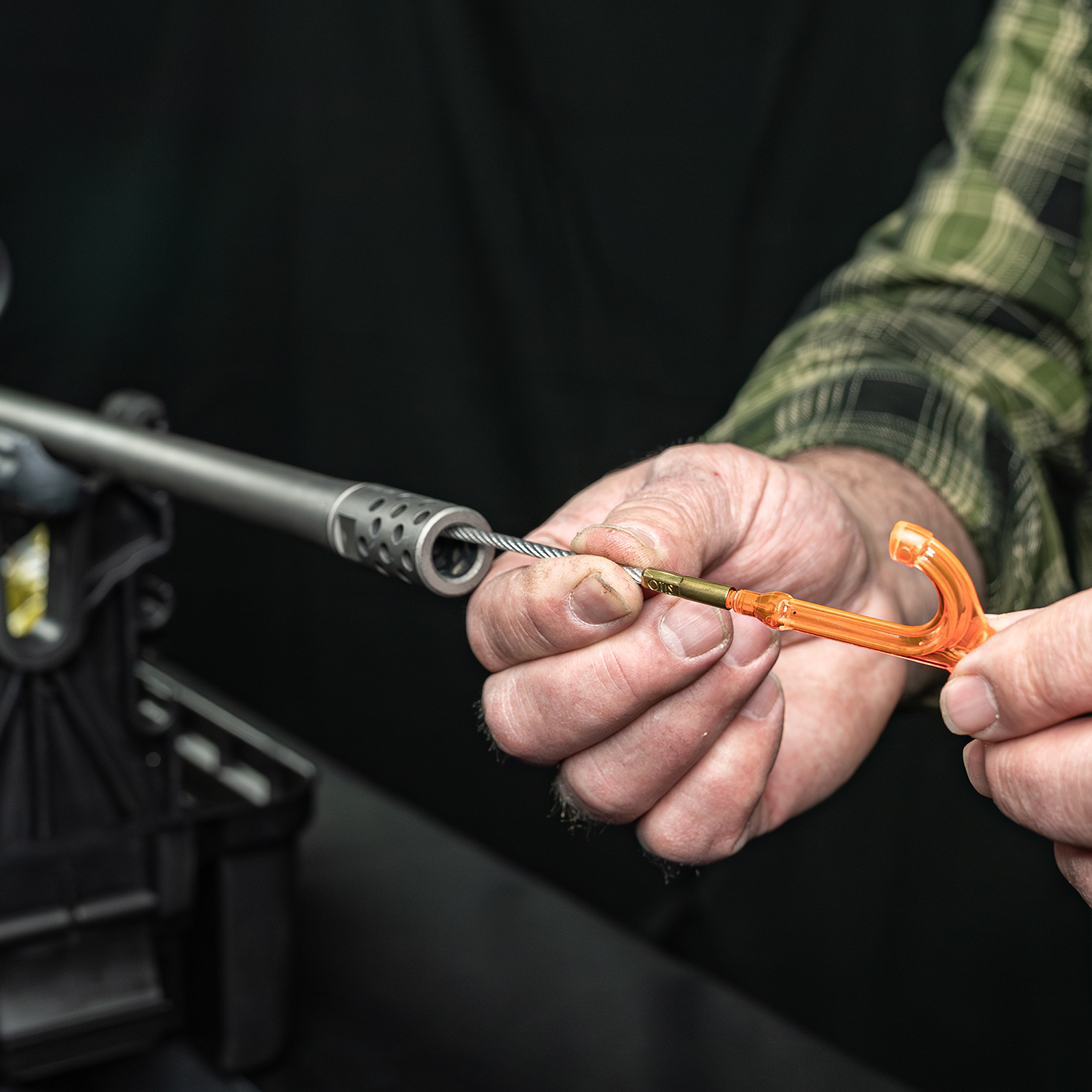 LIfestyle image of Otis Elite Range Box, Universal Gun Care System Bore Reflector+ in use as pull handle on Otis Ripcord