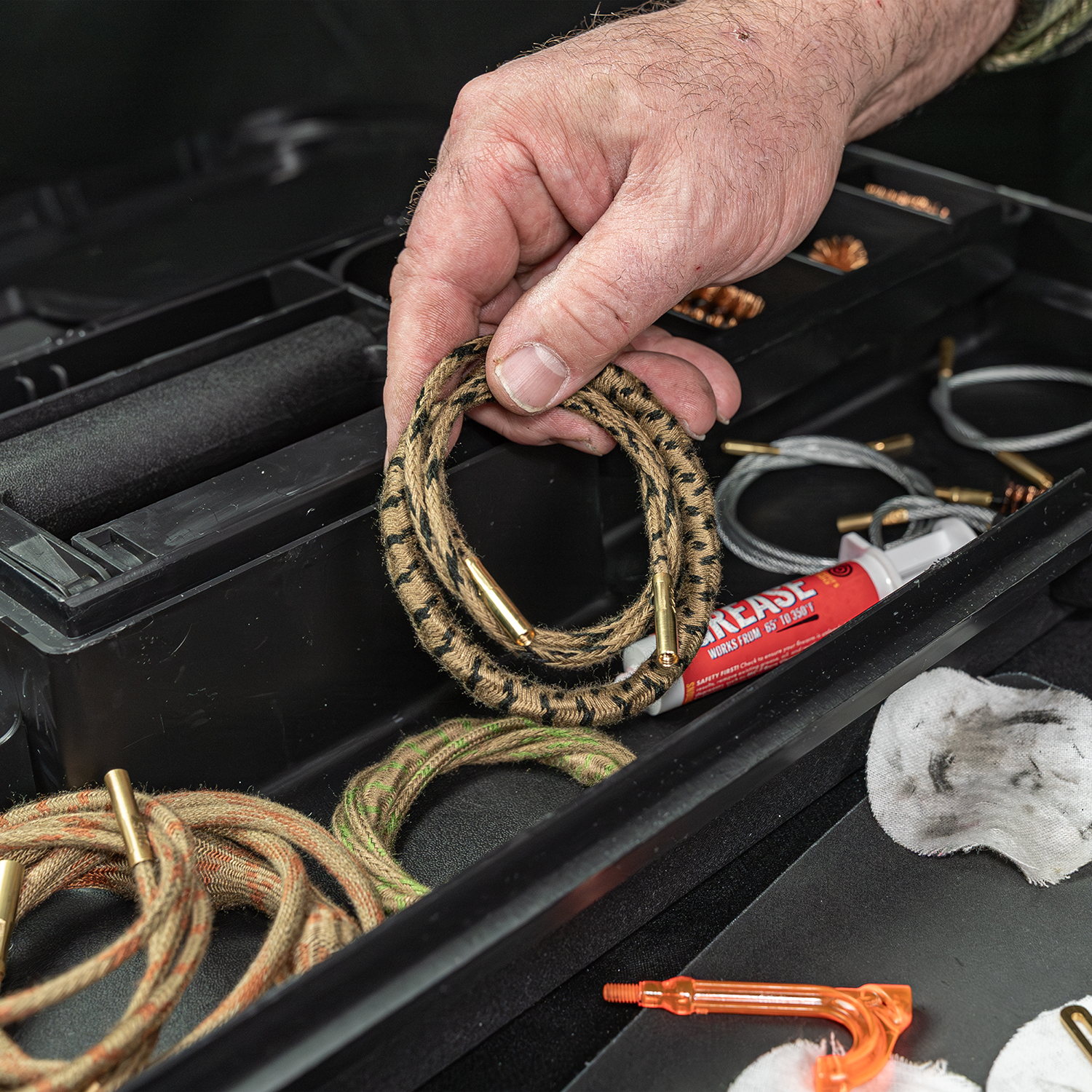 LIfestyle image of Otis Elite Range Box, Universal Gun Care System ripcord being removed from range box