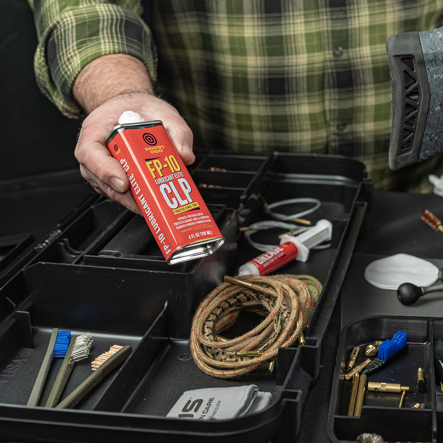 LIfestyle image of Otis Elite Range Box, Universal Gun Care System FP-10 CLP being removed from box