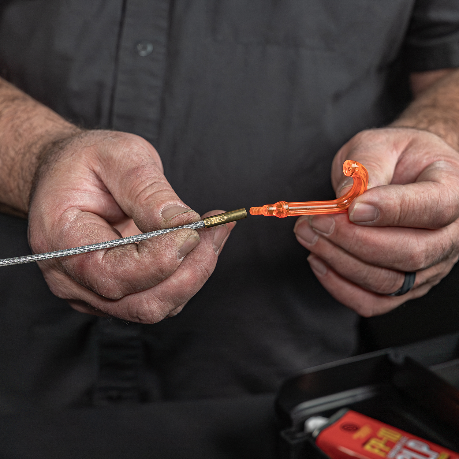 Lifestyle image of Otis Technology AR Elite Range Box Gun Care System for .223/5.56 Bore Reflector+ shown in use as a t-handle on memory flex cable