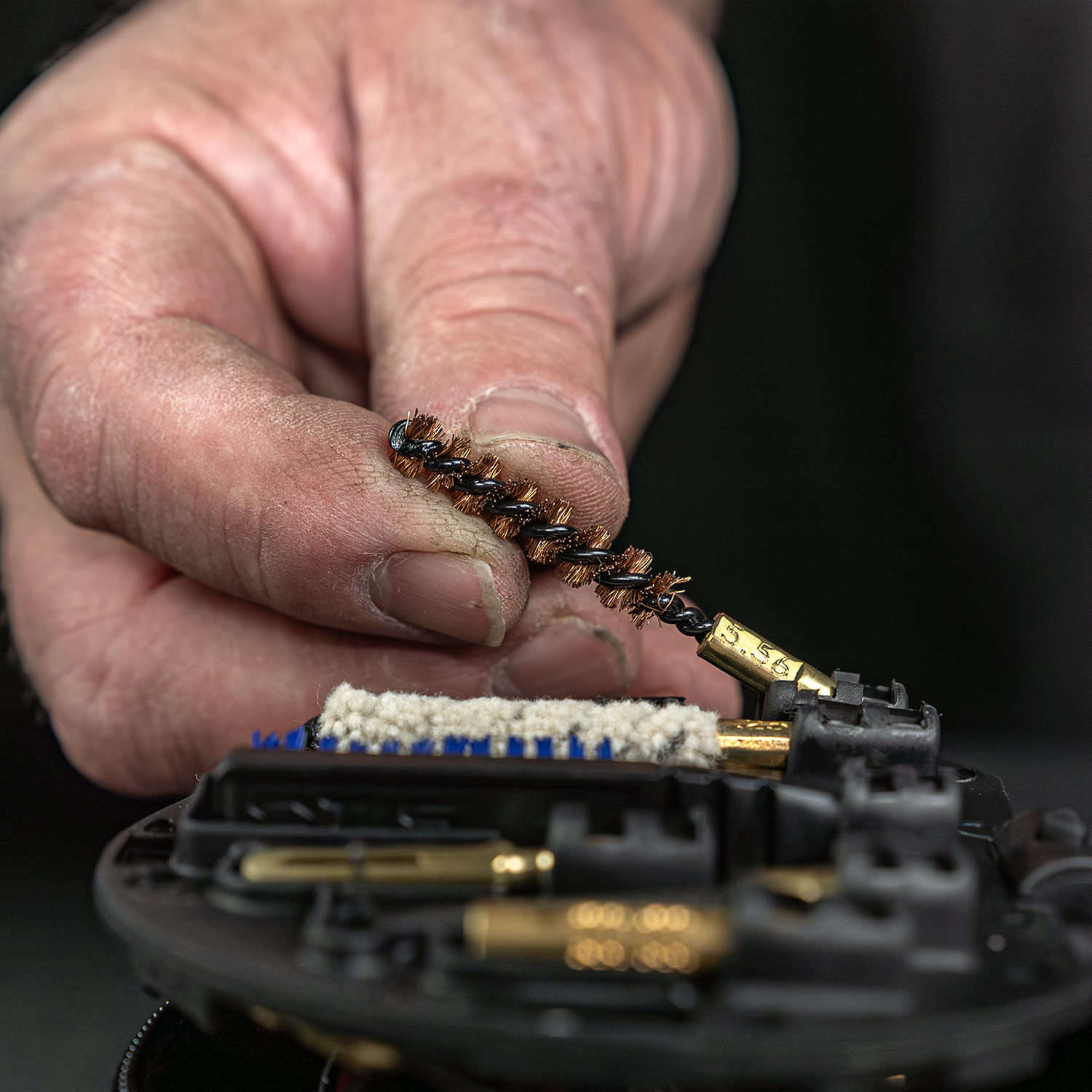 Lifestyle image of Otis Technology AR Elite Range Box Gun Care System for .223/5.56 bronze bore brush being removed from MSR/AR cleaning kit includd in AR Elite Range Box