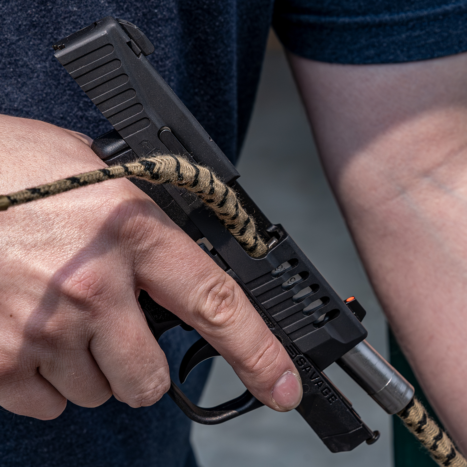 Lifestyle image of image of Otis Technology .38/9mm/.357cal Ripcord® Deluxe Kit showing the ripcord in use on the Savage Stance 9mm Handgun