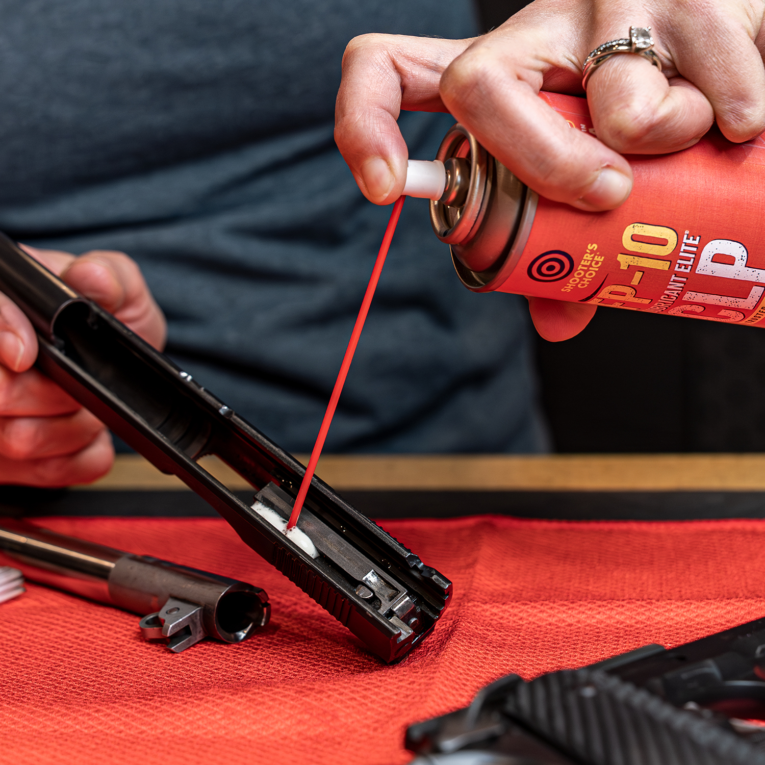 Lifestyle image of Shooter's Choice FP-10 Lubricant Elite® CLP Aerosol 4 oz  in use on pistol slide