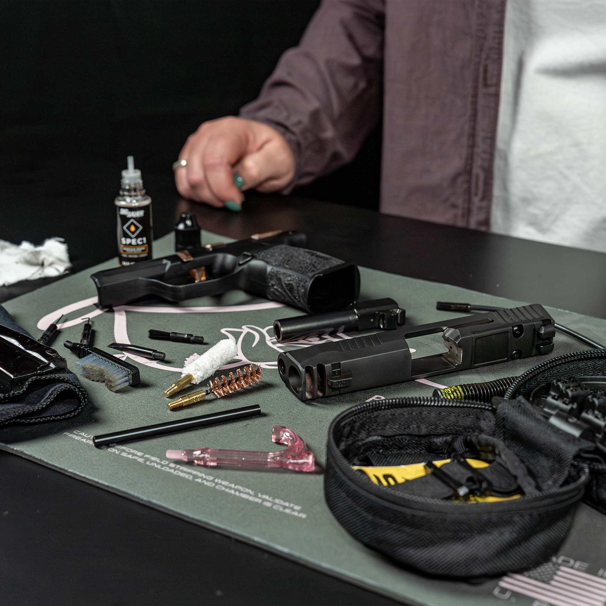 lifestyle image of  image of Otis Technology ROSE™ by Sig Sauer 9mm Cleaning Kit in use