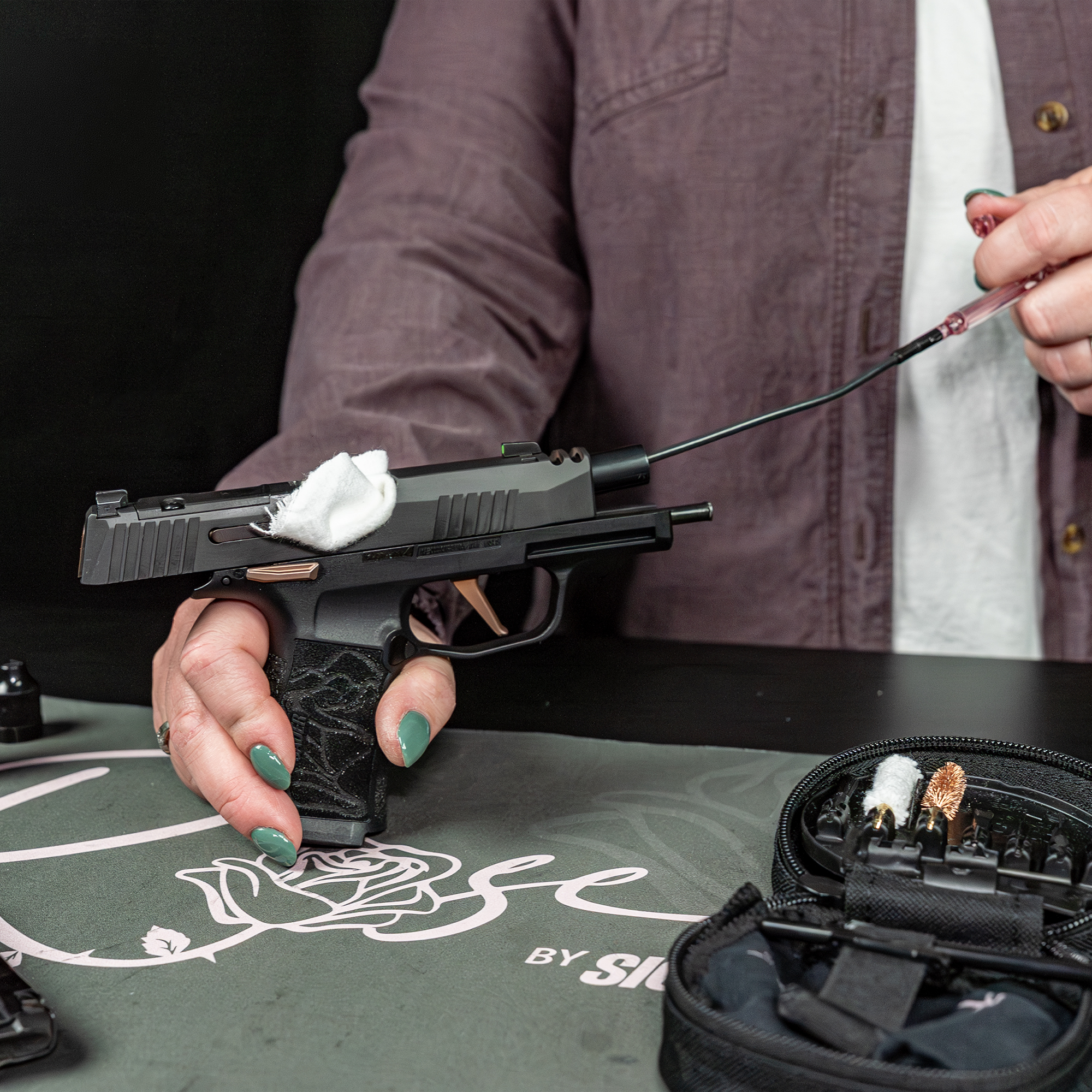 lifestyle image of  image of Otis Technology ROSE™ by Sig Sauer 9mm Cleaning Kit in use