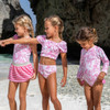Girls Pink Paradise swim set styled for a summer beach look.