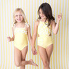 Girls wearing Butter Yellow Daisy one piece swimsuits.