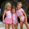 Girls wearing Pink Paradise long sleeve one piece swimsuits.