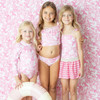 Girls wearing Pink Paradise tropical long sleeve one piece swimsuits.