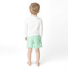 Boys mint swim trunks with shark icon print and comfortable elastic waistband, stylish kids swimwear from back.