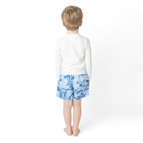 fit point of view of Shade Critters Denim Paradise boys  kids swimsuit trunks on boy with tropical blue print 