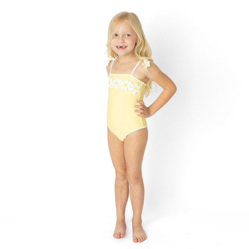 Girls Butter Daisy one piece swimsuit on model showing fit.