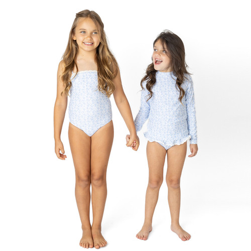 Girls blue floral rashguard swimsuit with long sleeves and matching bottoms, stylish kids swimwear shown on models.