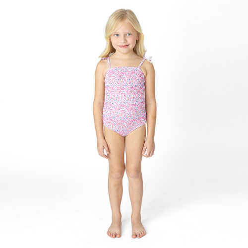 Shade Critters girls smocked one piece swimsuit in electric daisy floral print, colorful kids swimwear shown on model.