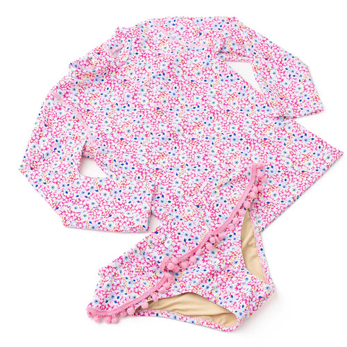 Girls long sleeve rashguard bikini set in ditsy floral print with vibrant colors, stylish kids swimwear for sun protection.