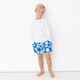 Boy wearing Shade Critters Blue Daisy Boys 4 Way Stretch Swim Trunk