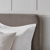 Close-up of the rounded corner and piped edge on the Como upholstered bedhead