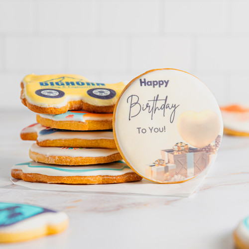 Cookie stacks with a round birthday cookie leaning on stacked cookies